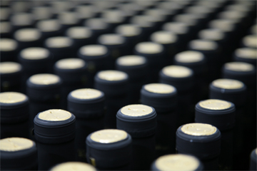 Na slici se vidi mnoštvo vrhova začepljenih boca vina, prostiru se kroz cijelu sliku.